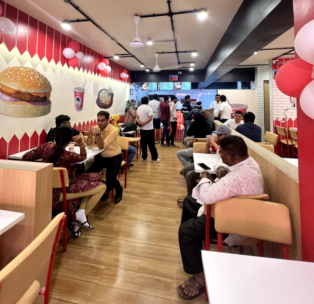 A burger and coffee outlet with customers sitting at tables