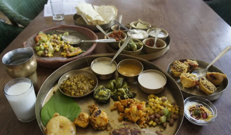 A metallic plate consisting of small portions of various Gujarati dishes