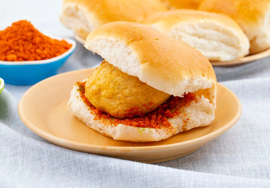 Vada pav with spiced potato filling and tangy chutneys.