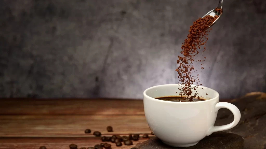 Top view of coffee beans in a plate with empty coffee cups on both sides