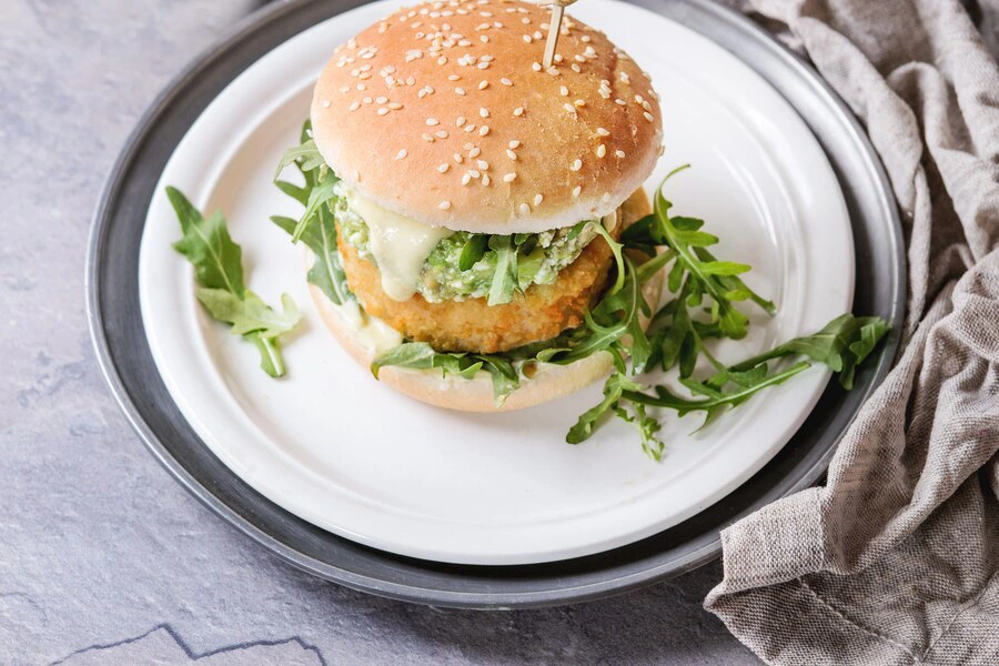 Paneer burger with a soft patty and fresh vegetables.